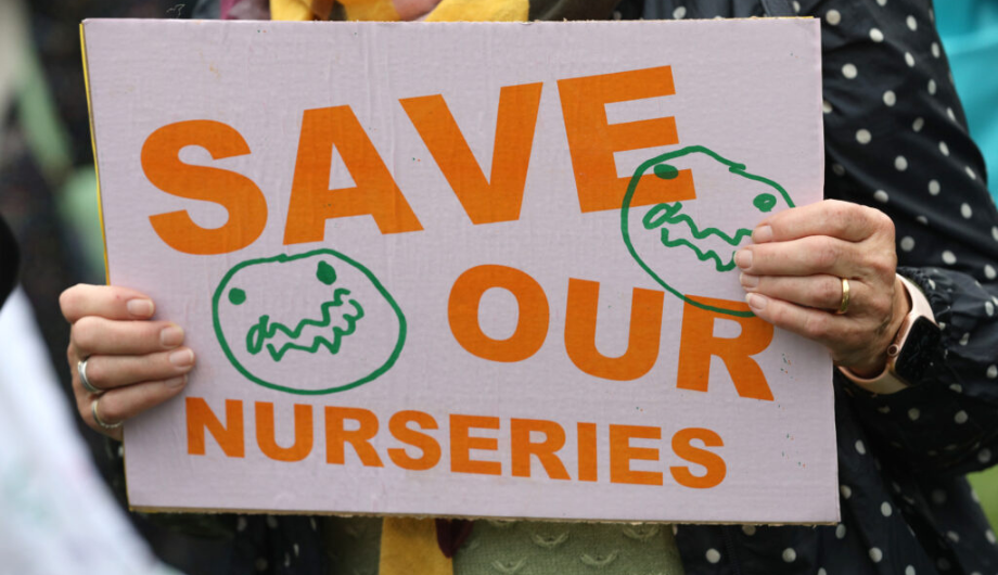 Person holding up save our nurseries sign