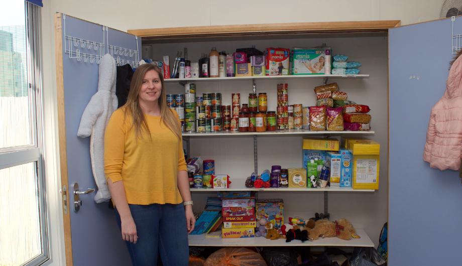 Nursery Manager standing in front of the Nursery's foodbank