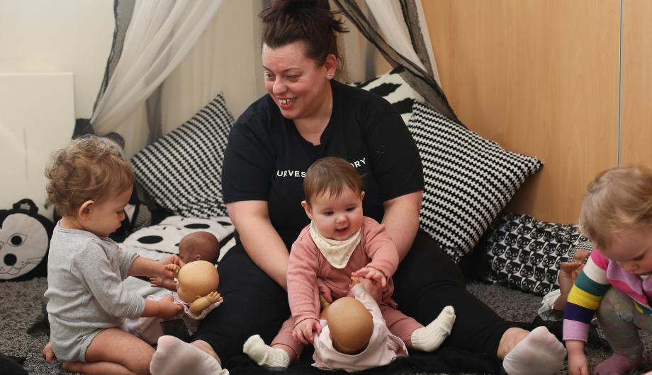 babies playing with baby dolls